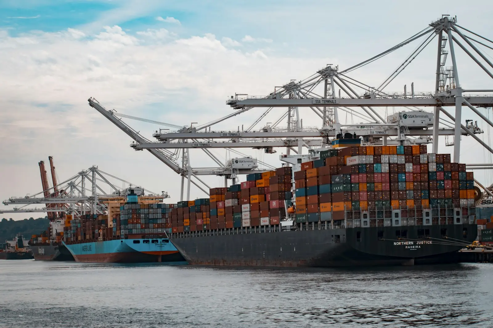 Cranes loading containers onto a ship